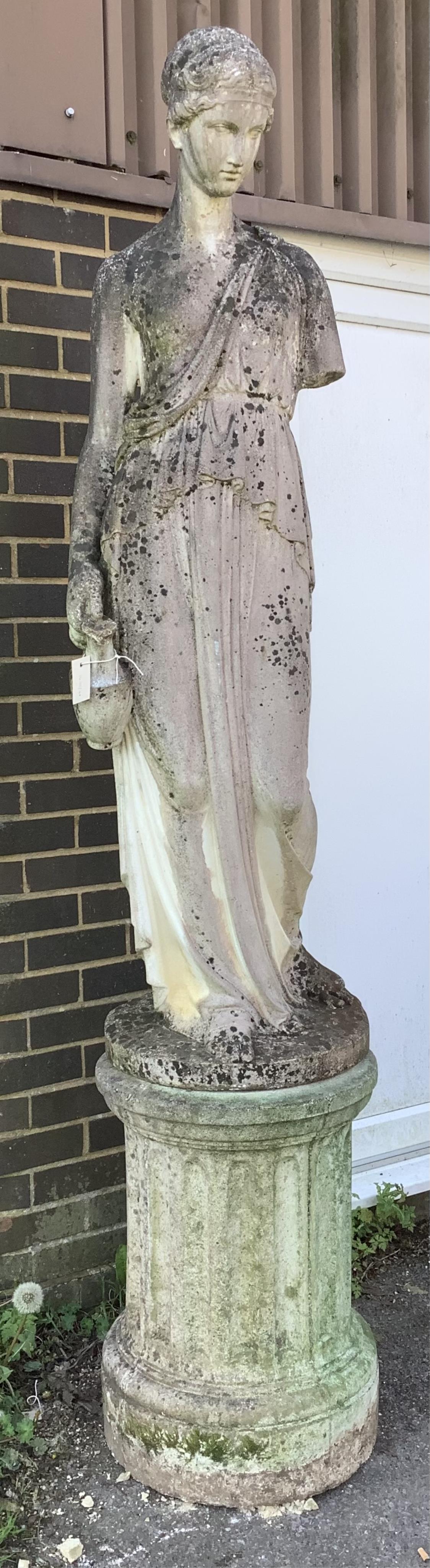 A large reconstituted stone female water carrier garden statue on circular fluted plinth, height 222cm